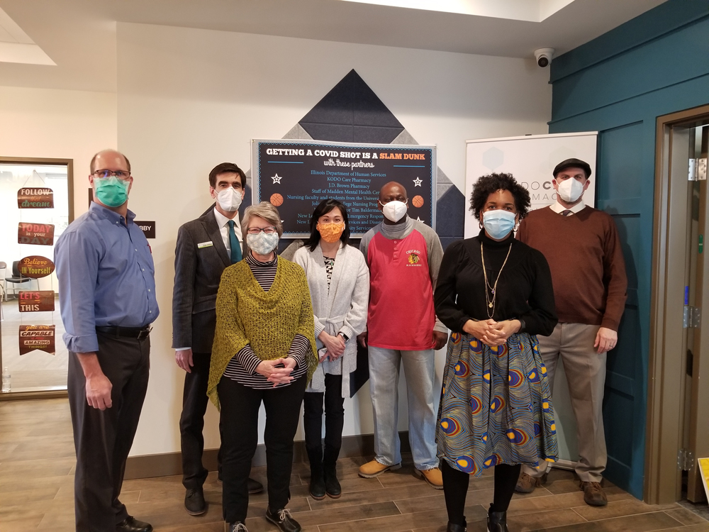 Lt. Gov. Juliana Stratton (2nd from right) and Secretary of IDHS Grace Hou (4th from right) visit (L to R) Jim Pritz (J.D. Brown Pharmacy); Chad Kodiak (KODO Care Pharmacy); Carolyn Cochran Kopel (IDHS); and Tim Gunter & Thane Dykstra (Trinity Services).