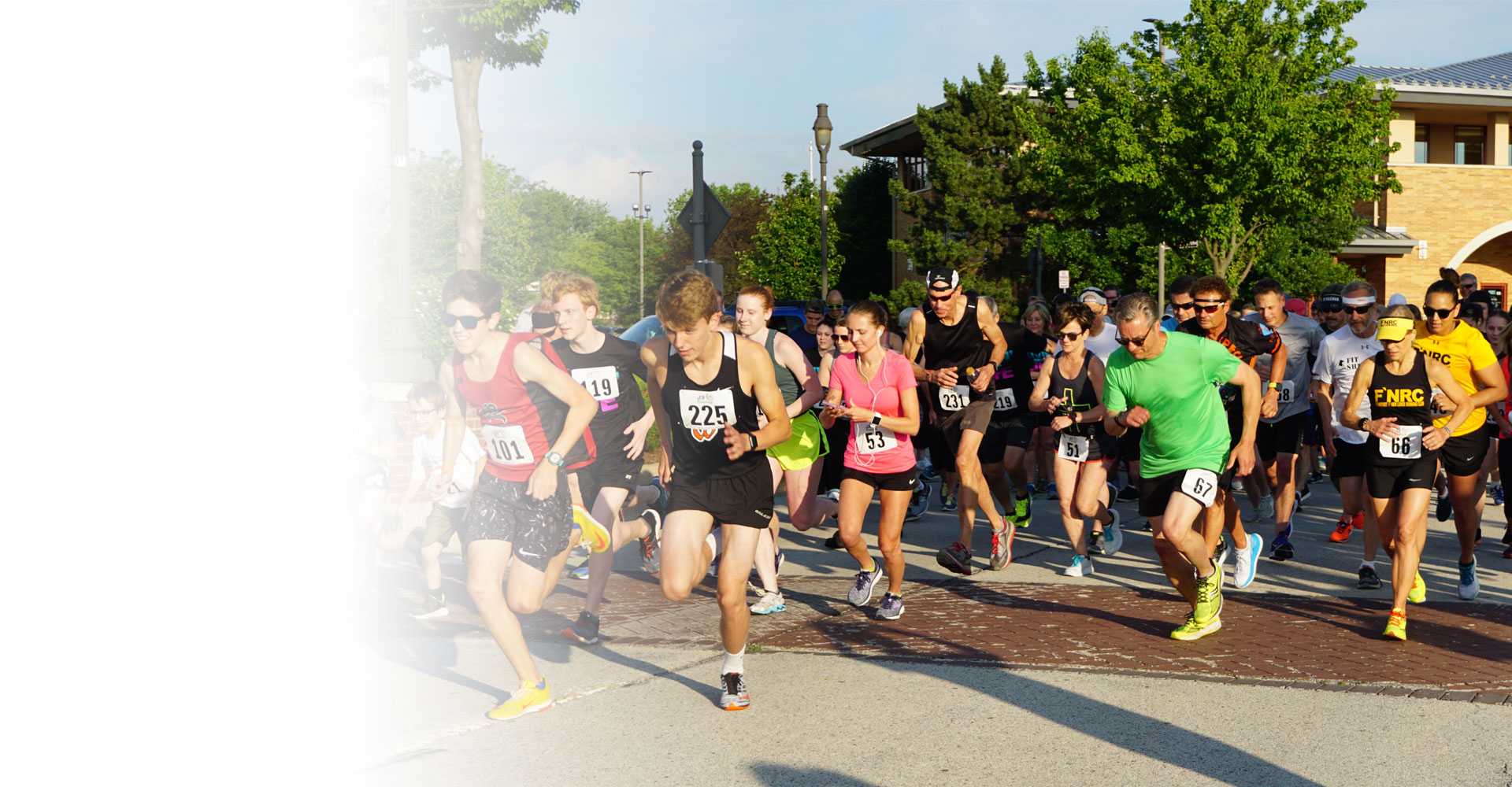 Group of people taking off from starting line at past Trinity Triumph 5K race